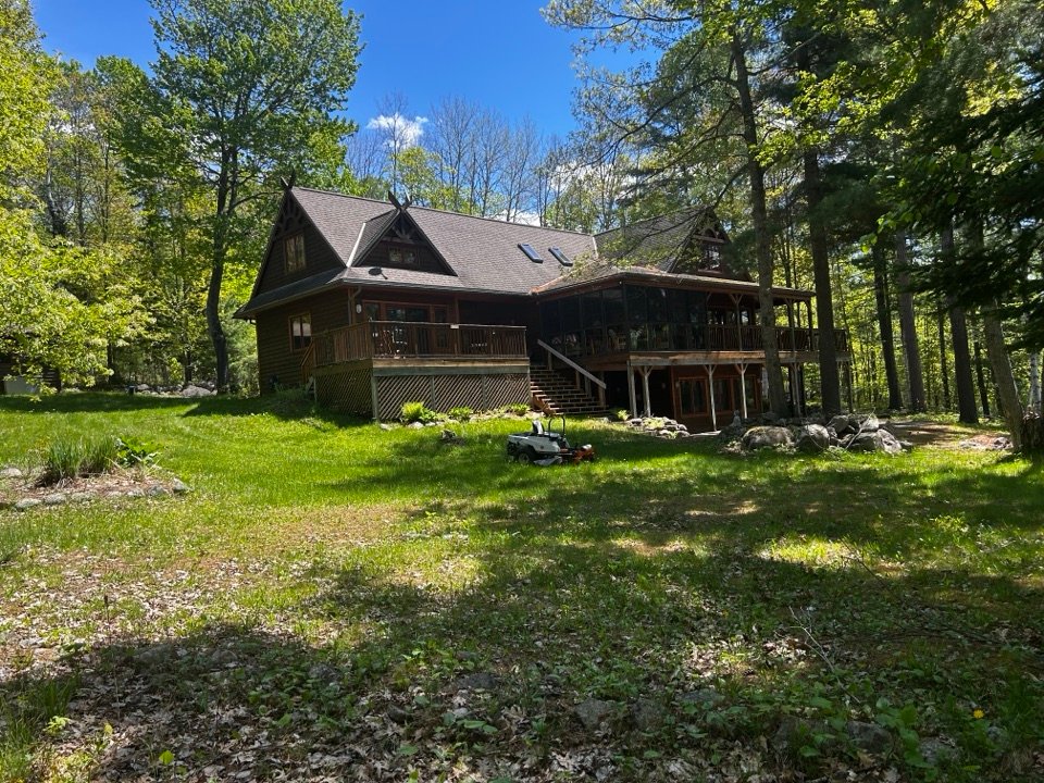 Mowing a wooded property lawn